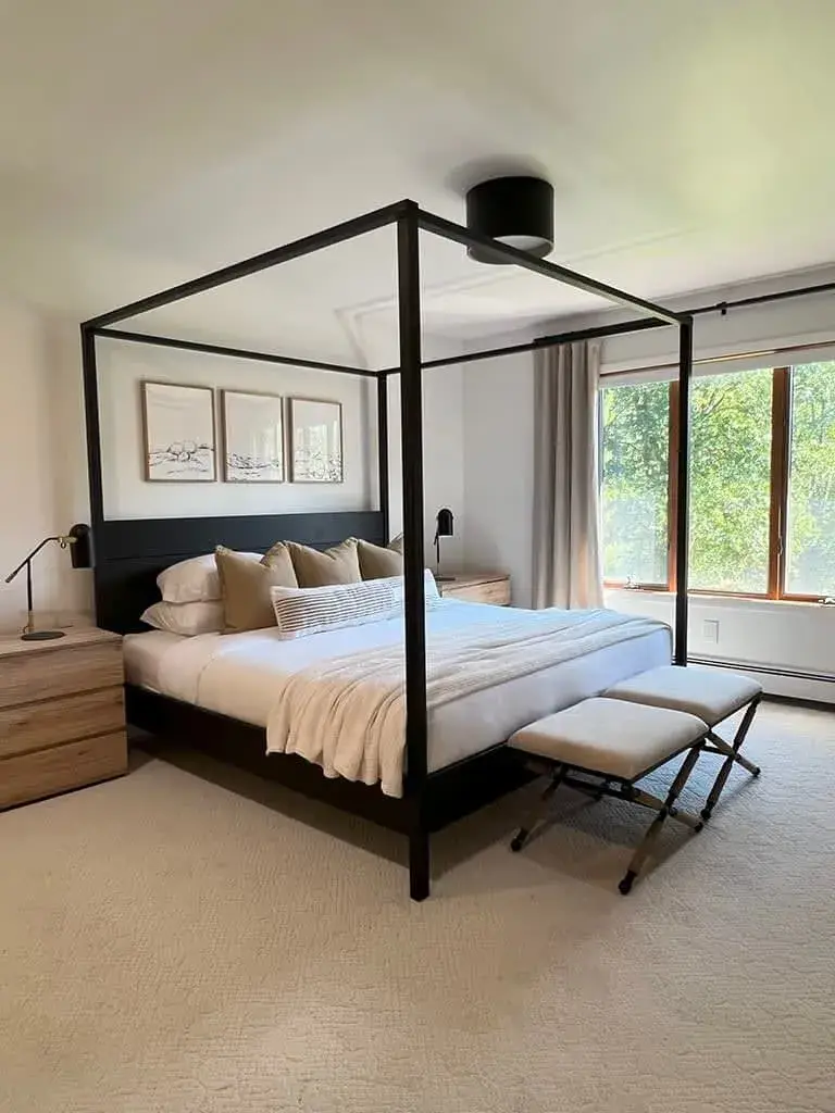 Bedroom 1 at The Acrewoods, a king canopy bed with windows on two sides
