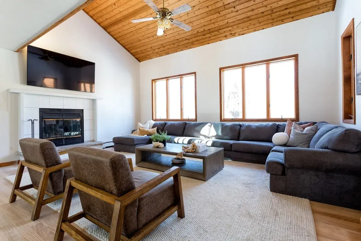 The 16-foot sectional in the living room, facing the fireplace and a 70-inch TV