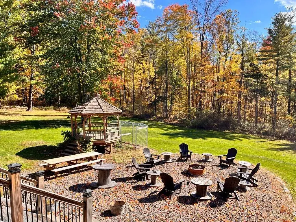 The fire pit in late fall, the gazebo and turning trees behind