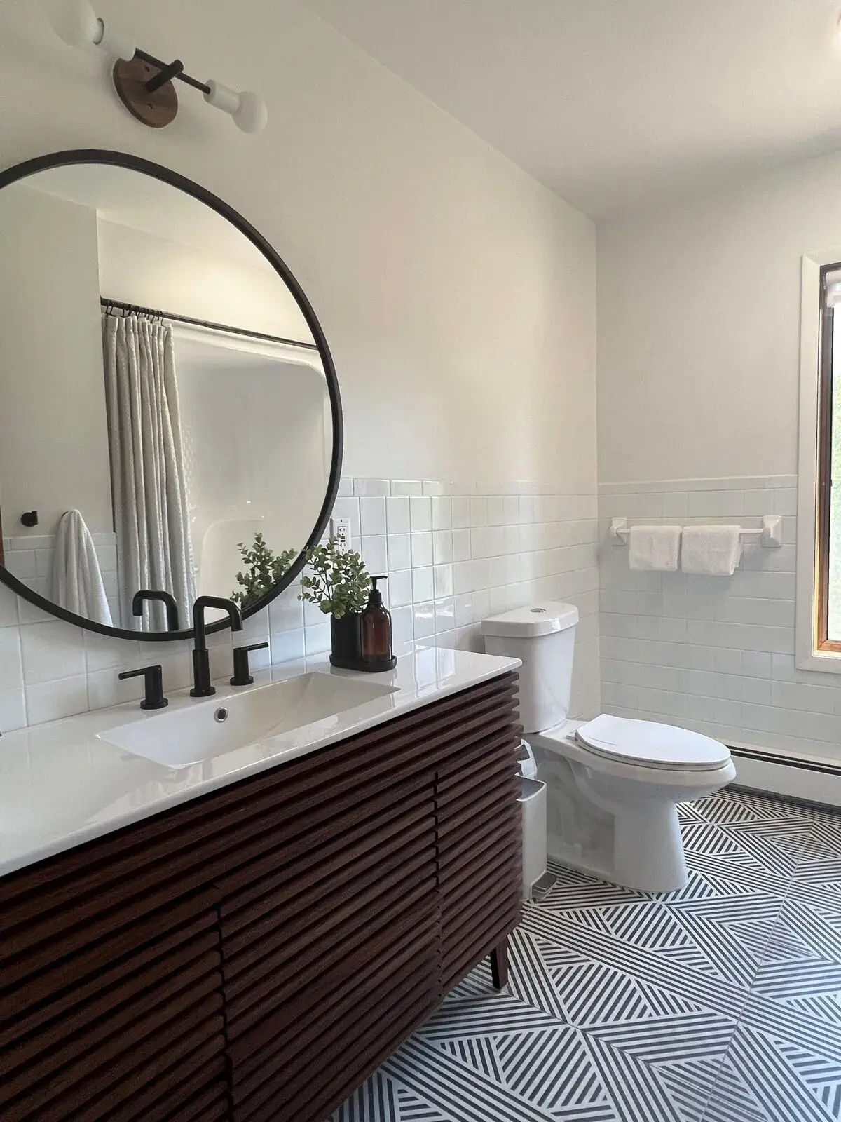 The updated second-floor bathroom in a modern farmhouse style