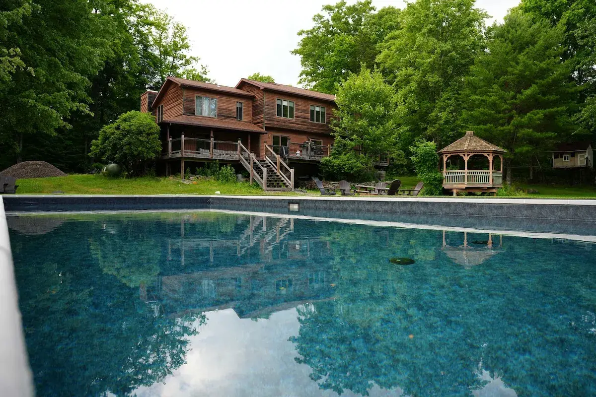 The house and gazebo reflected in the pool