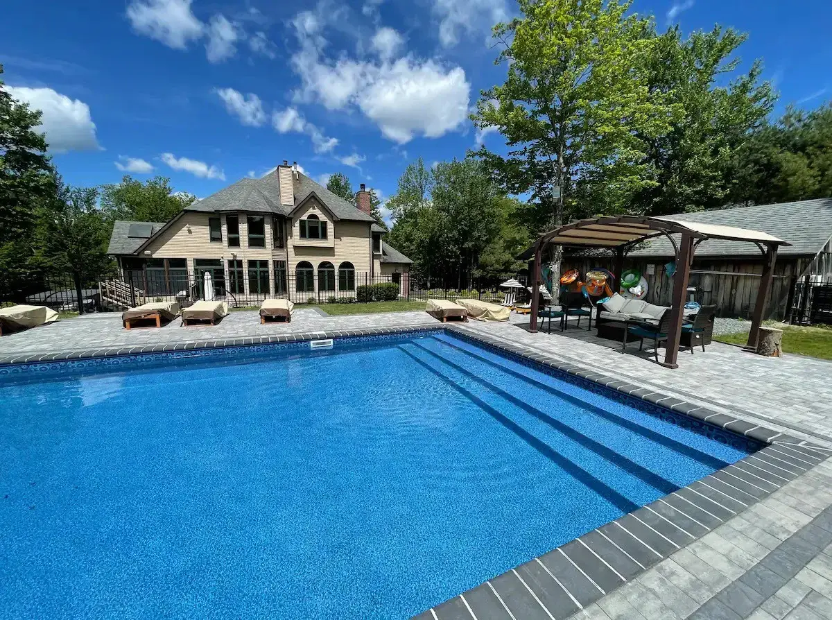 The heated pool at The Birch Estate, the main house and pergola beyond