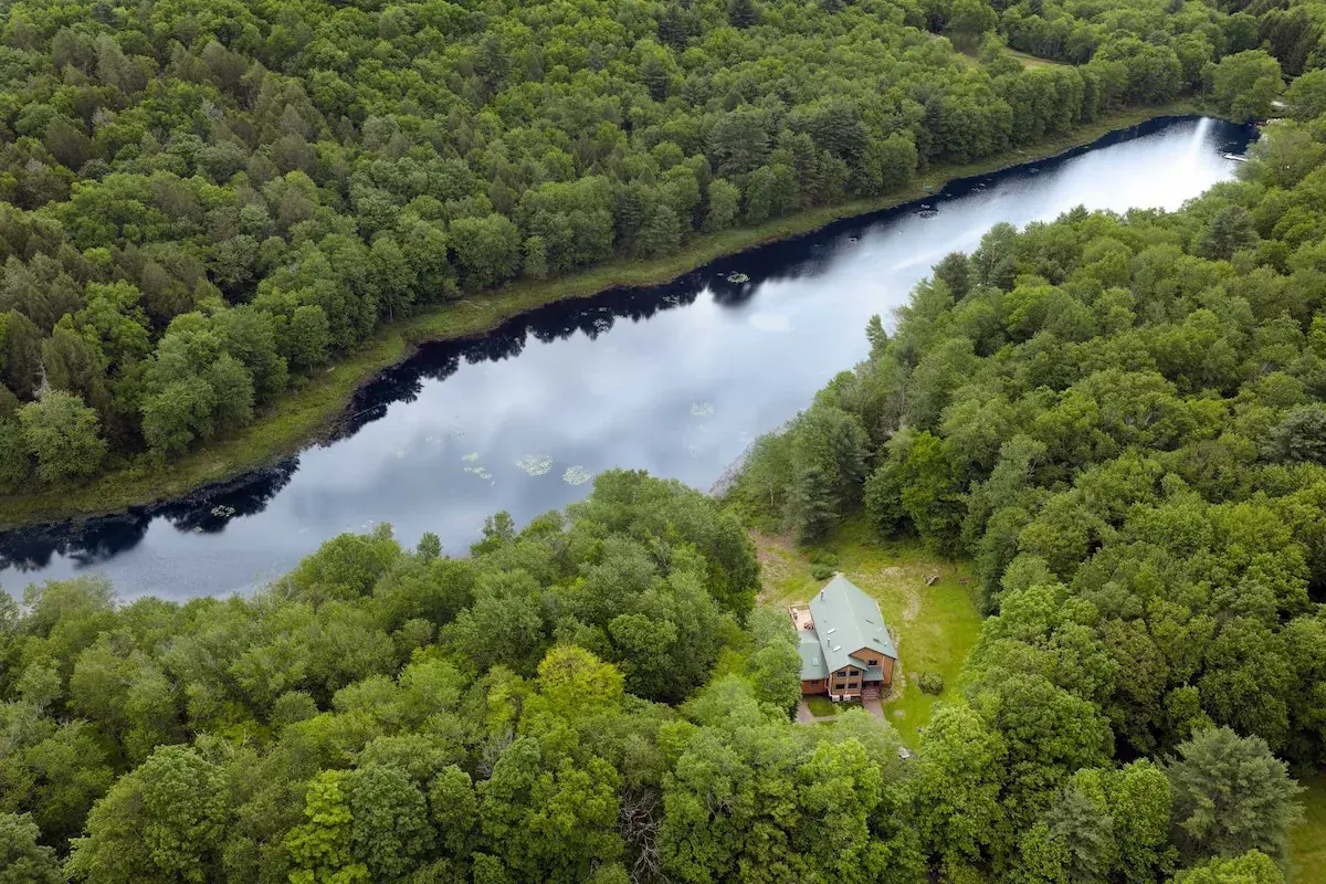 The Lake House from the air, the lake and forest around it