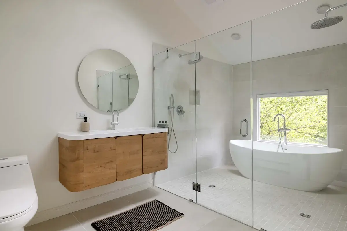 A bathroom with a freestanding tub and a glass shower