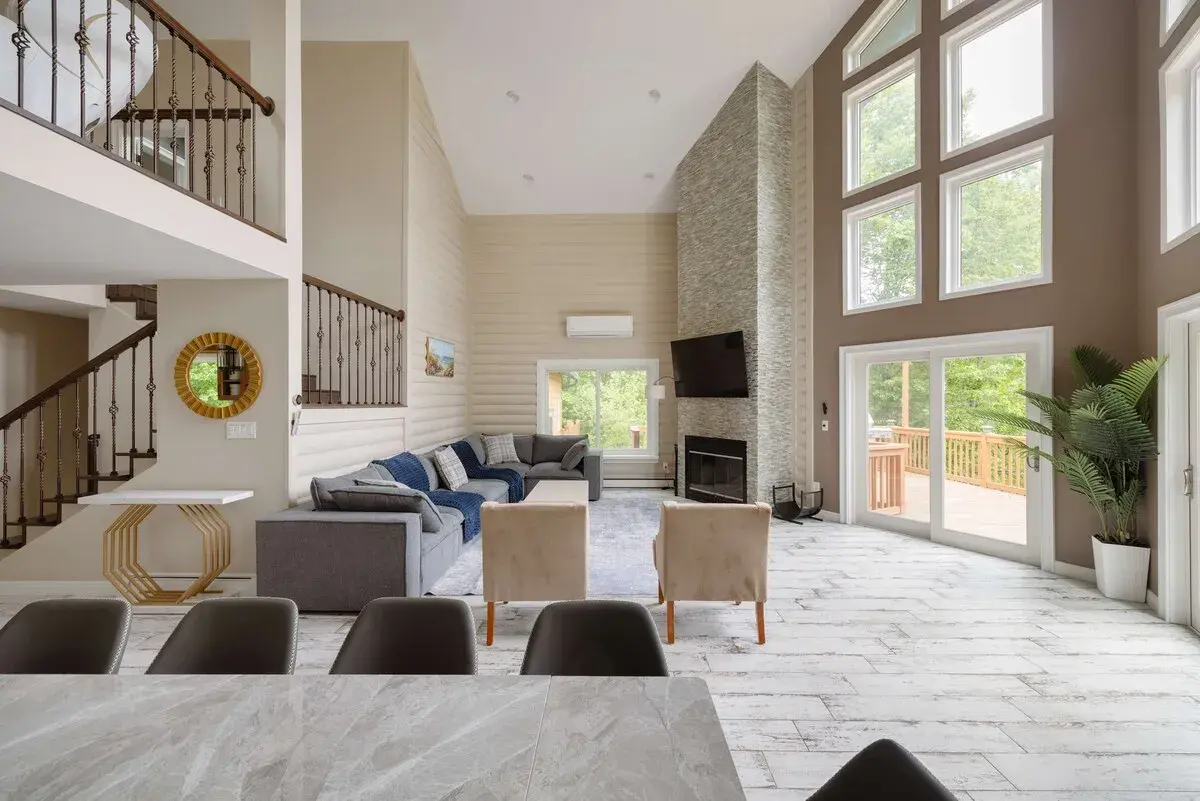 The great room from the dining table, the stair and fireplace beyond