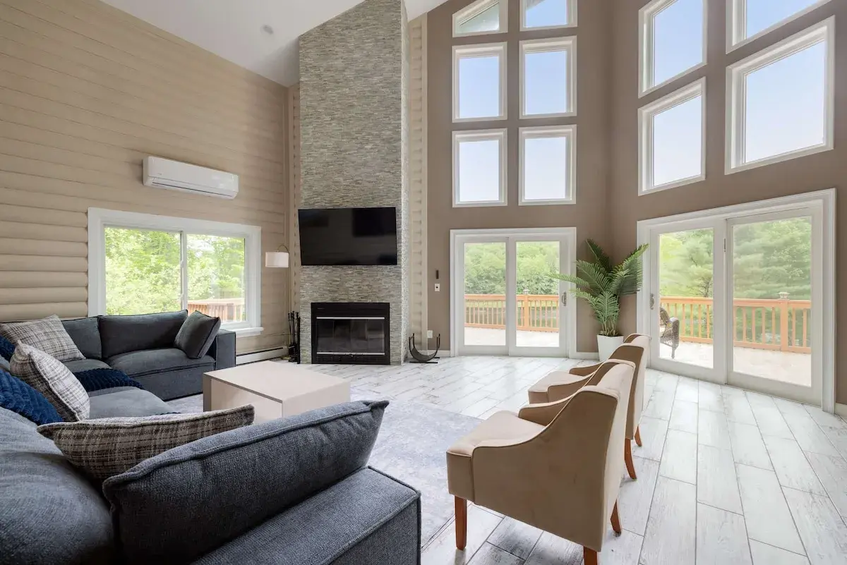 The living area by the fireplace, glass doors to the deck