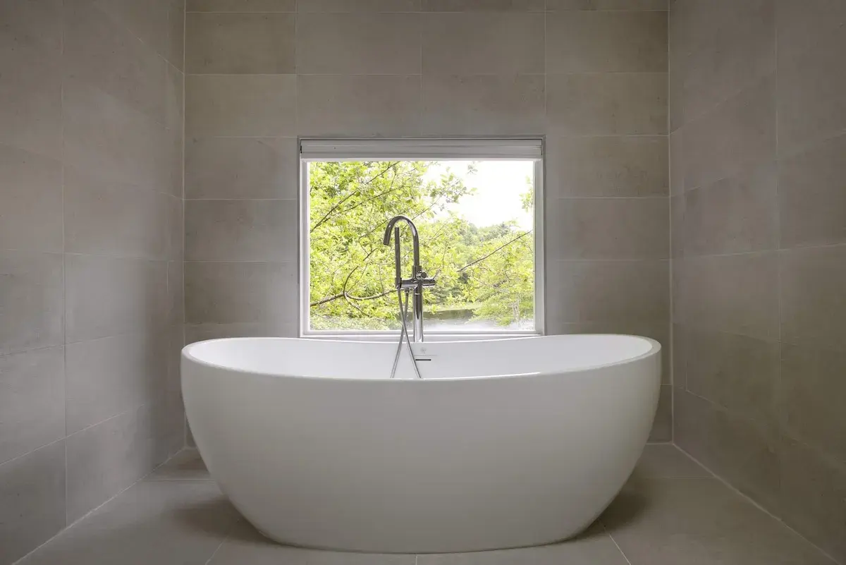 The deep soaking tub beneath a window