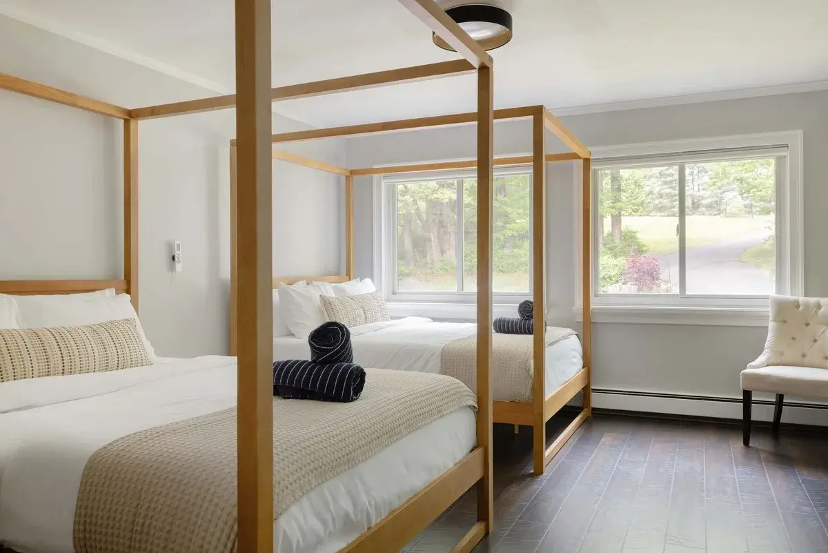 A bedroom with a wooden canopy bed